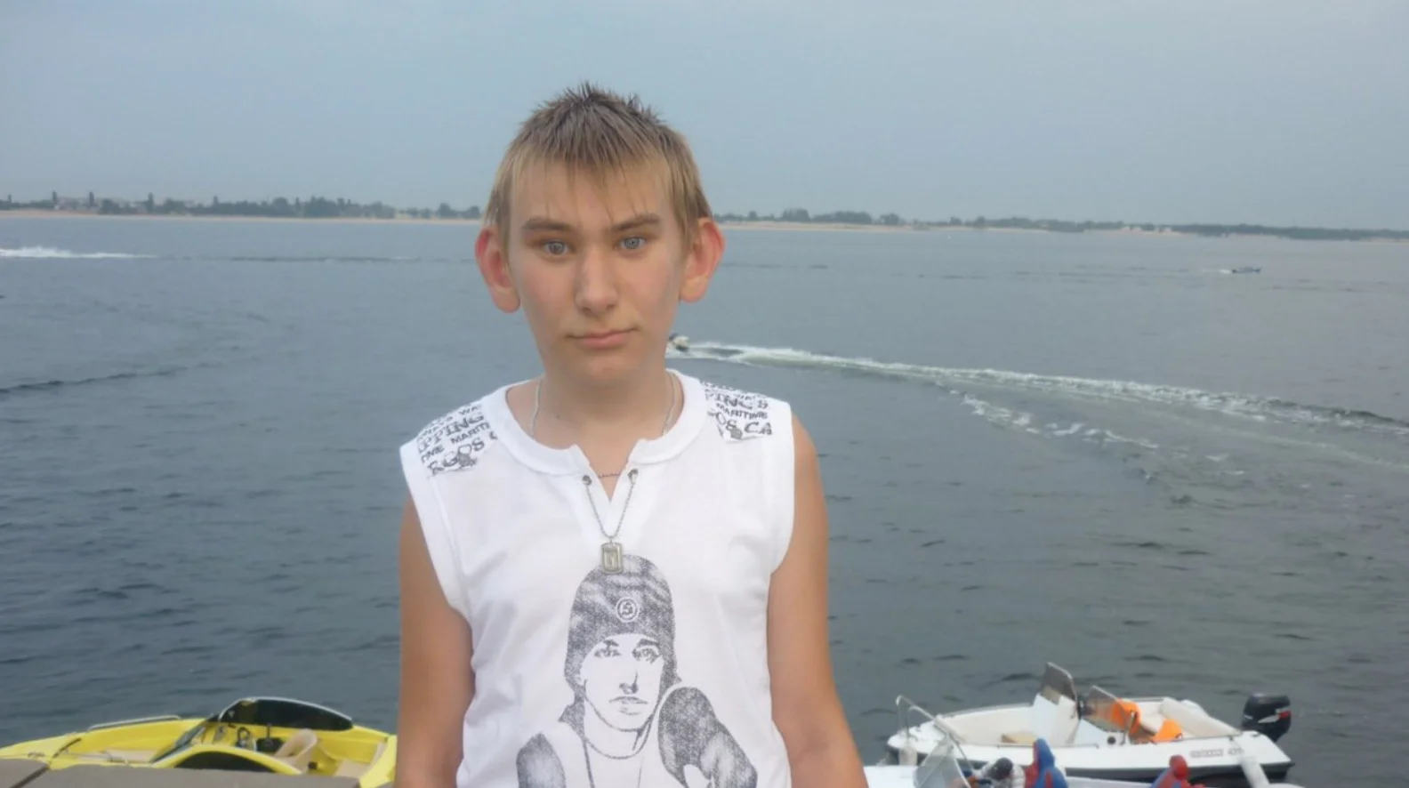 Sminem — A clean photograph of a young person wearing an Eminem t-shirt standing on a beach without text overlay.