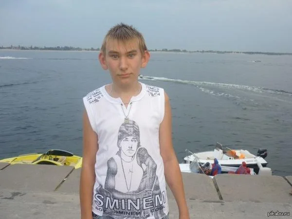 A photograph of a young person wearing an Eminem shirt with 'SMINEM' text prominently displayed.