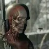 Sniper Elite Headshot — Close-up of Sniper Elite 4 x-ray kill cam showing soldier's exposed skull and musculature in helmet.
