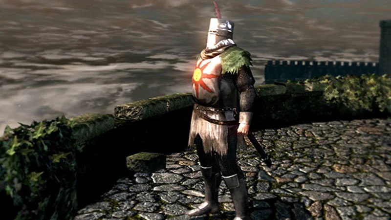 Solaire Of Astora — Definitive Dark Souls screenshot of Solaire in prayer-like pose with both arms raised and glowing sun symbol.