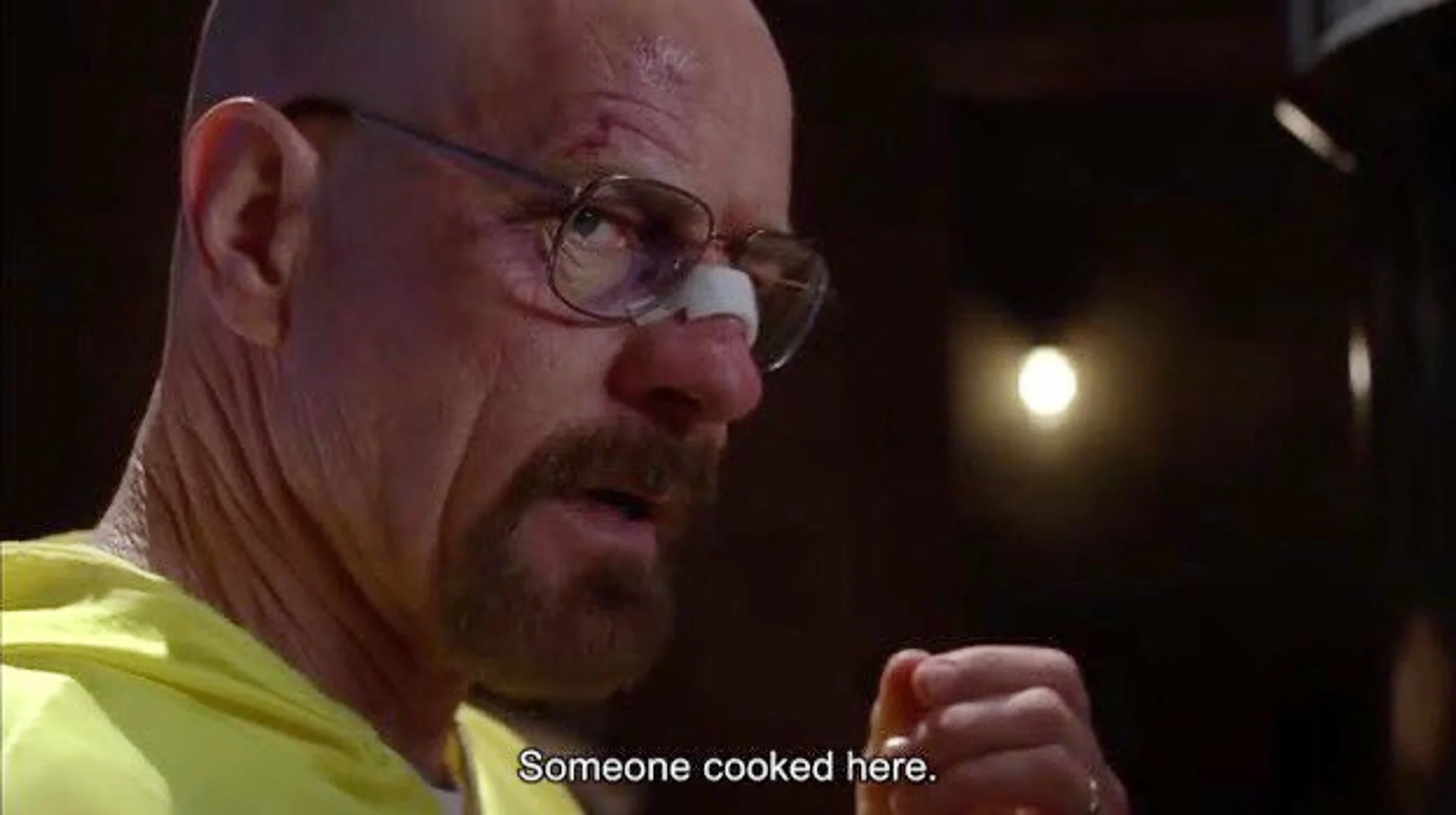 Walter White in yellow hazmat suit with subtitle 'Someone cooked here.'