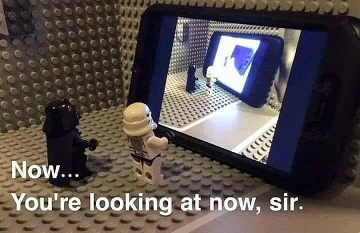 LEGO minifigures recreating the 'Now, you're looking at now, sir' scene from Spaceballs on a phone screen.