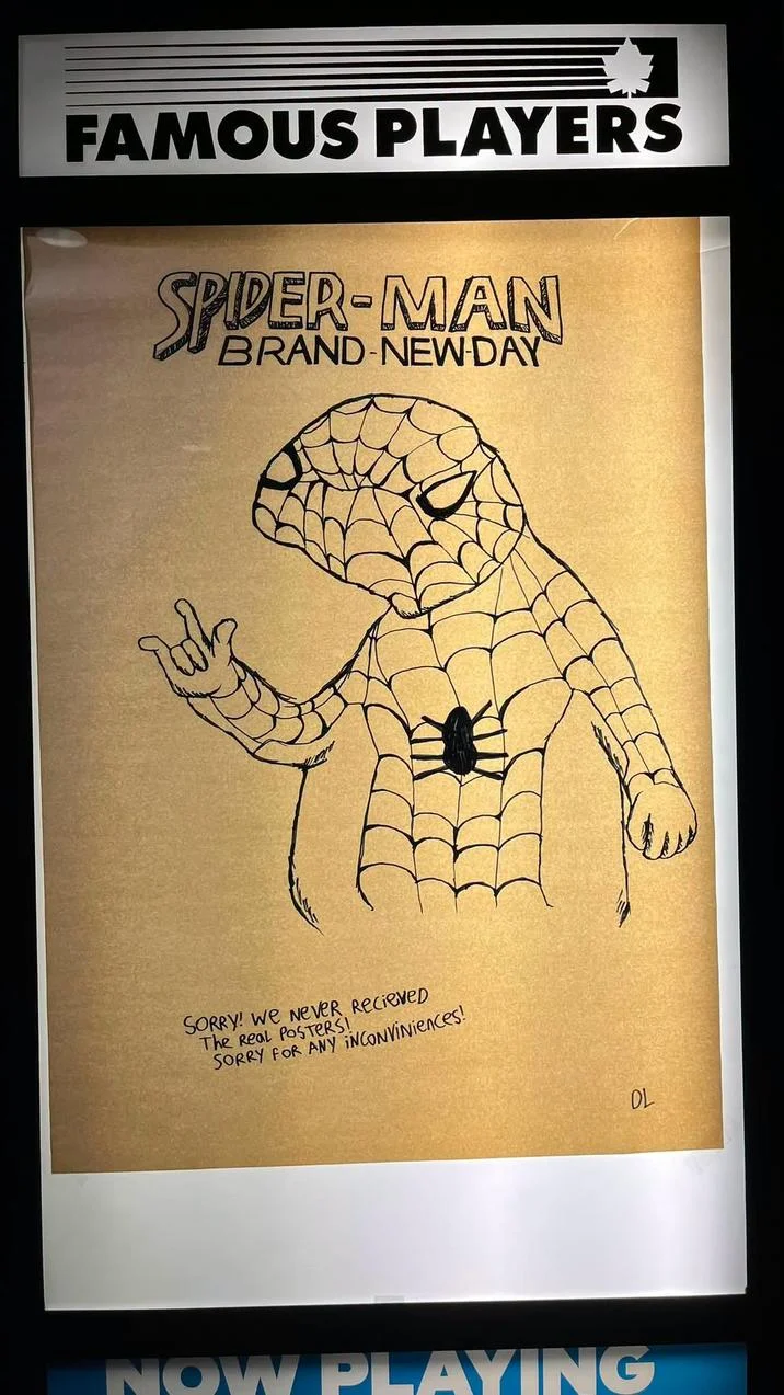 Movie theater poster case displaying a hand-drawn Spoderman-style Spider-Man Brand New Day poster