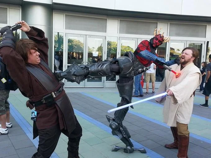 Star Wars: The Clone Wars — Convention cosplayers as Anakin and Obi-Wan fighting General Grievous and Darth Maul.