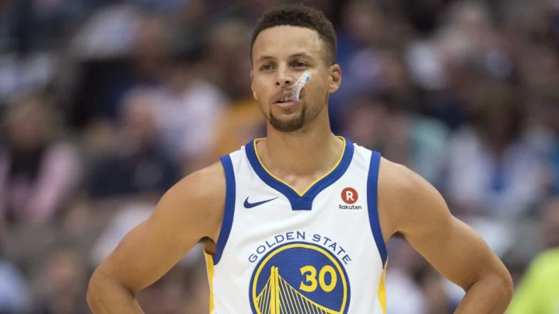 Stephen Curry in Golden State Warriors white #30 jersey with nose bandage