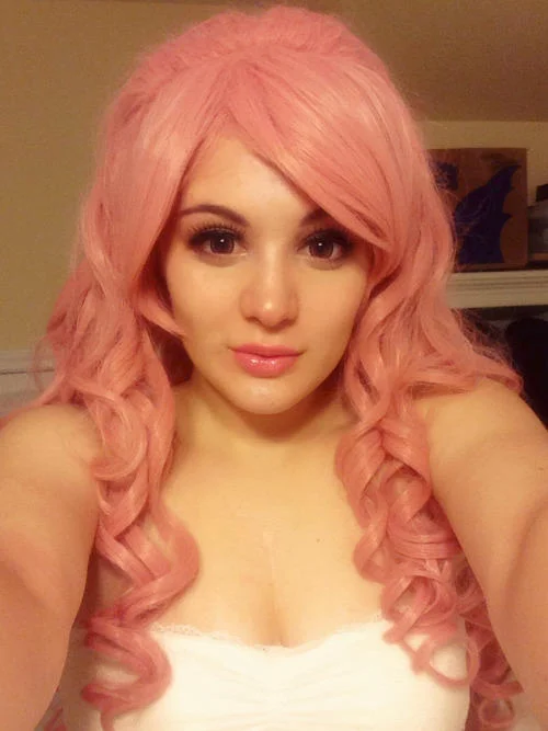 Steven Universe — Cosplayer with long curly pink hair and white top styled as Rose Quartz.