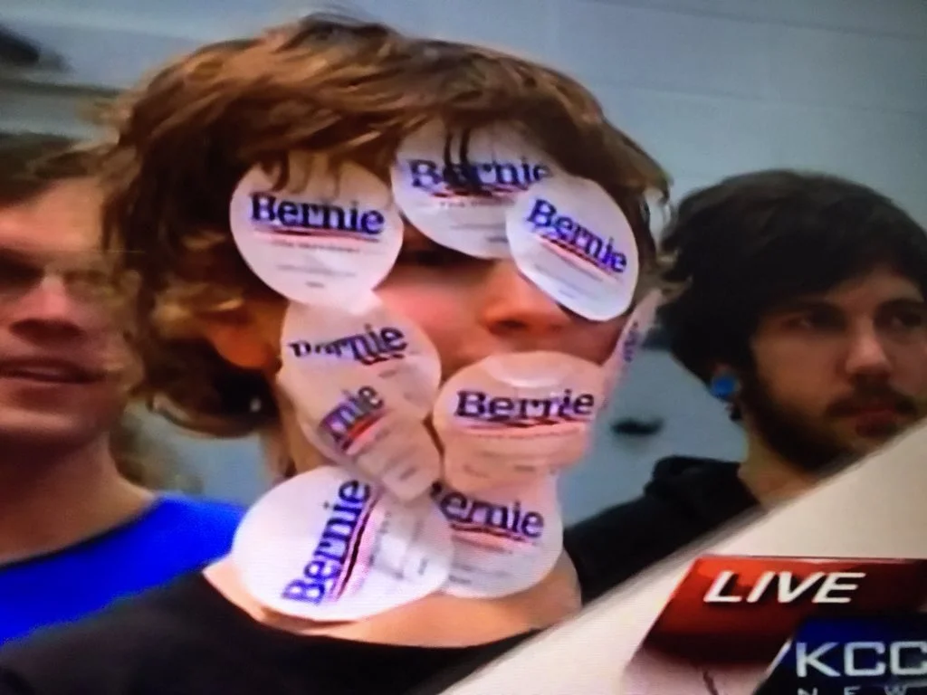 Sticker Boy — Young man with many Bernie Sanders stickers covering his face on live KCCI News broadcast