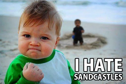 Success Kid at beach with determined expression celebrating disliking sandcastles.