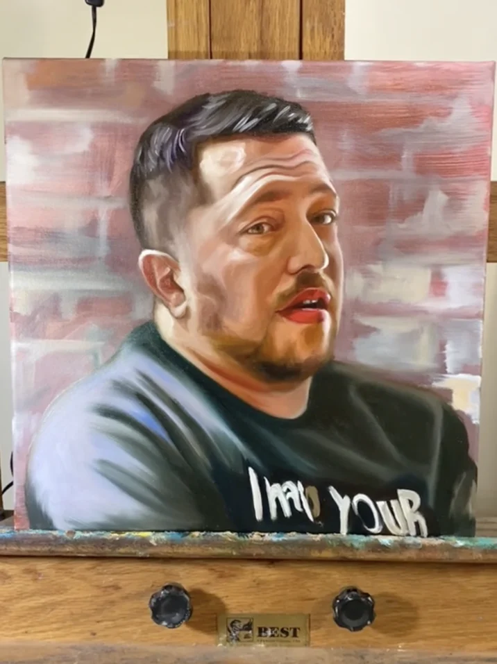 Oil painting portrait of the Tanka Jahari meme subject on an easel