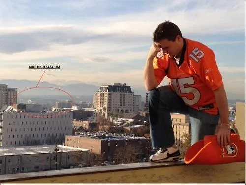 Player in red jersey performing Tebowing on high vantage point with Mile High annotation.