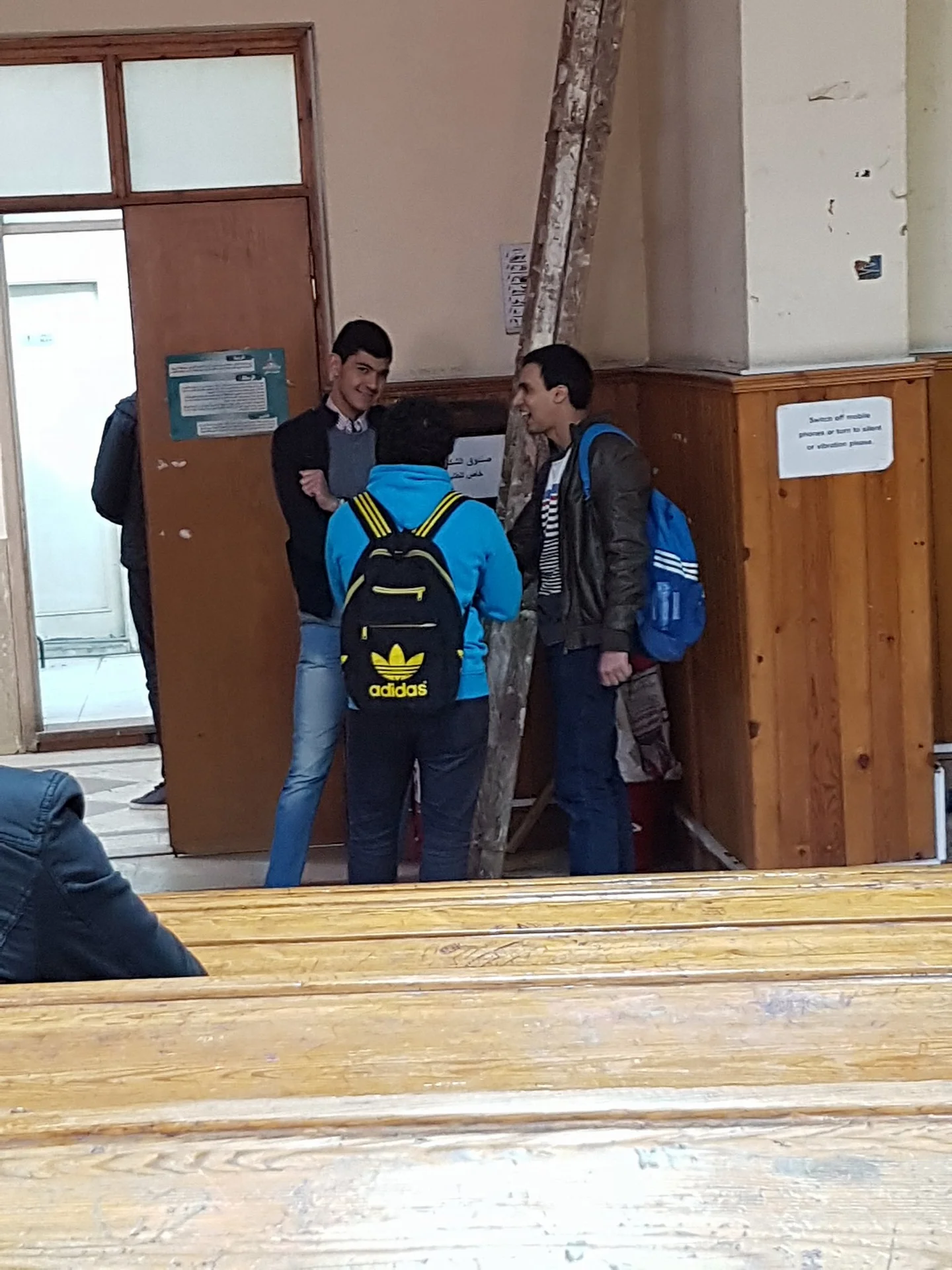 Tenso — Zoom in on a man giving a side-eye to an anime cosplayer holding a pillow
