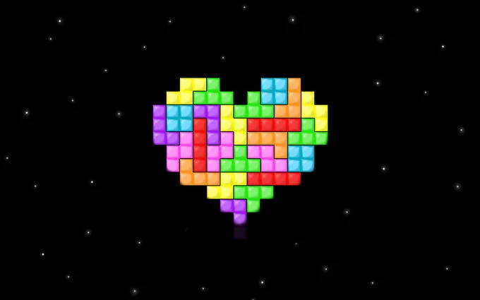 A rainbow heart built from Tetris blocks on a starry black background