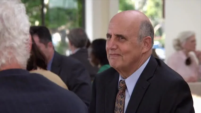 Thanks I Hate It — Man in business attire with visibly unimpressed disapproving expression.
