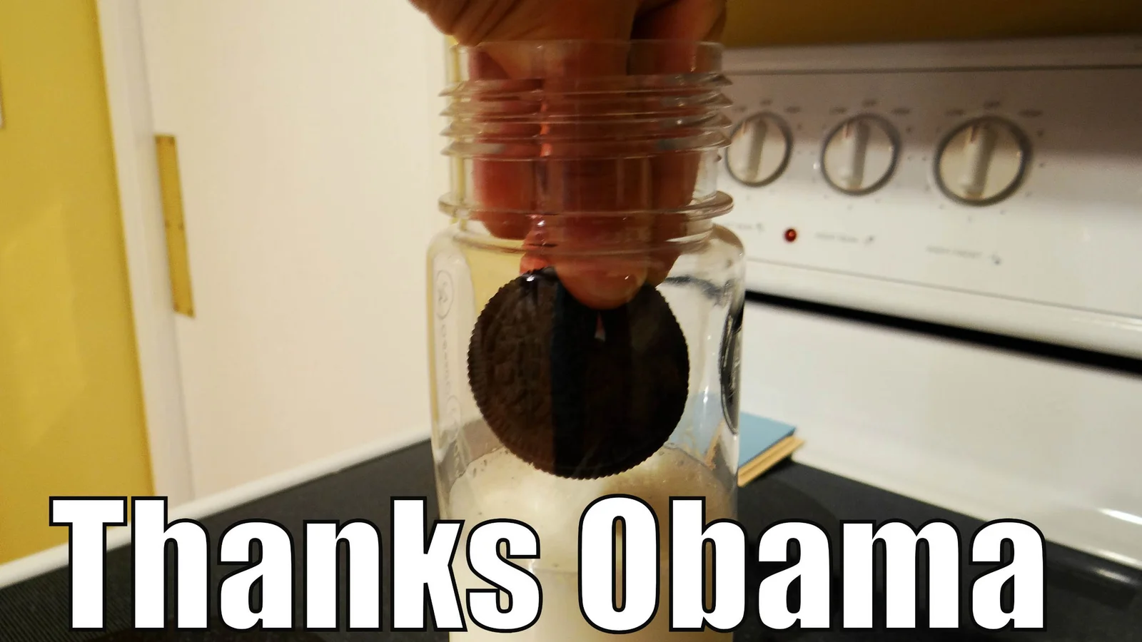 Thanks Obama — President Obama at Oval Office desk holding glass of milk in formal suit.