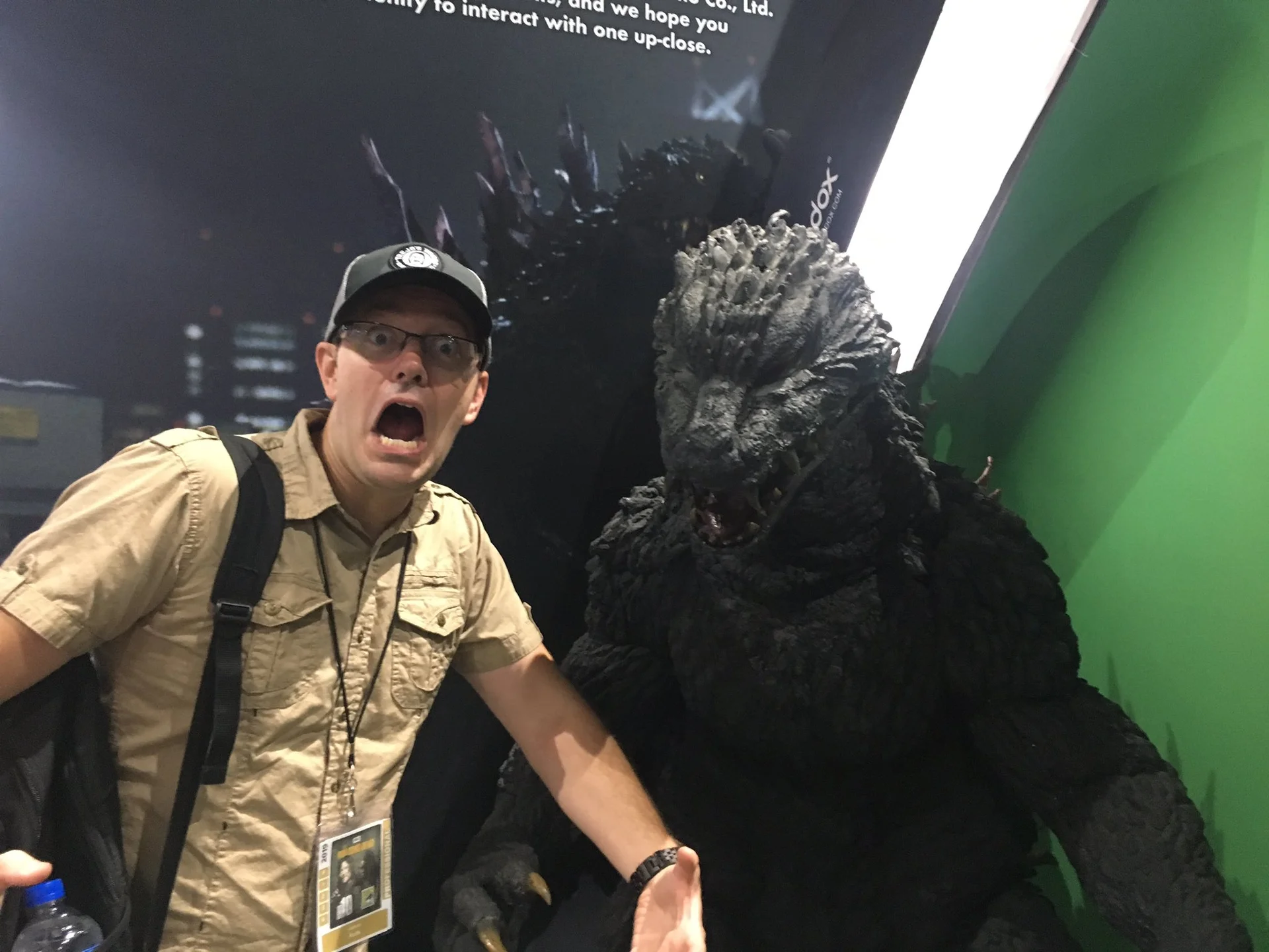 The Angry Video Game Nerd — James Rolfe posing with an open-mouth surprised expression next to a life-size Godzilla statue