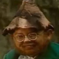 The Balkan Dwarf — Kekec character in glasses and traditional period clothing with distinctive hat.