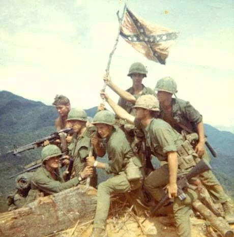 The Confederate Flag Debate — Vietnam War era U.S. soldiers posing with a raised Confederate flag on a hilltop