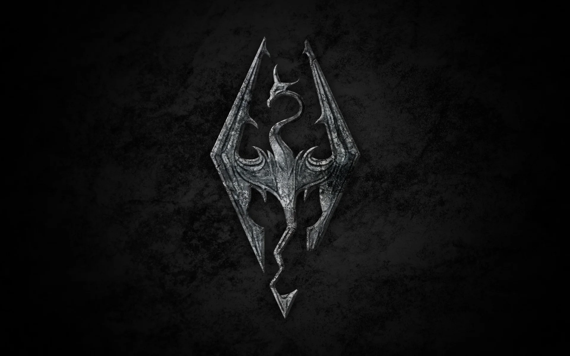 The Elder Scrolls — Skyrim dragon logo in silver metal on dark textured background