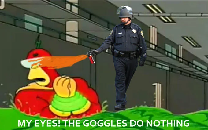 The Goggles Do Nothing! — Riot police officer pepper spraying Radioactive Man with caption My Eyes The Goggles Do Nothing