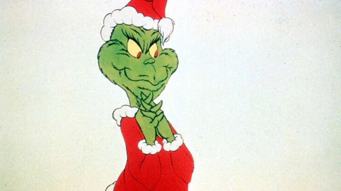 The Grinch — Classic cartoon Grinch in Santa hat with sinister smirk