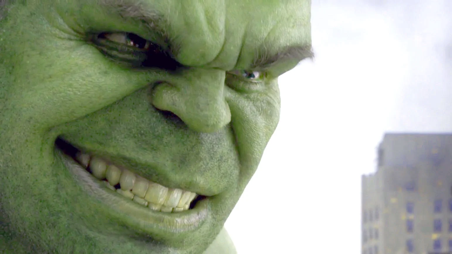 The Hulk GIF — Close-up of the Hulk's green face smirking with a toothy grin