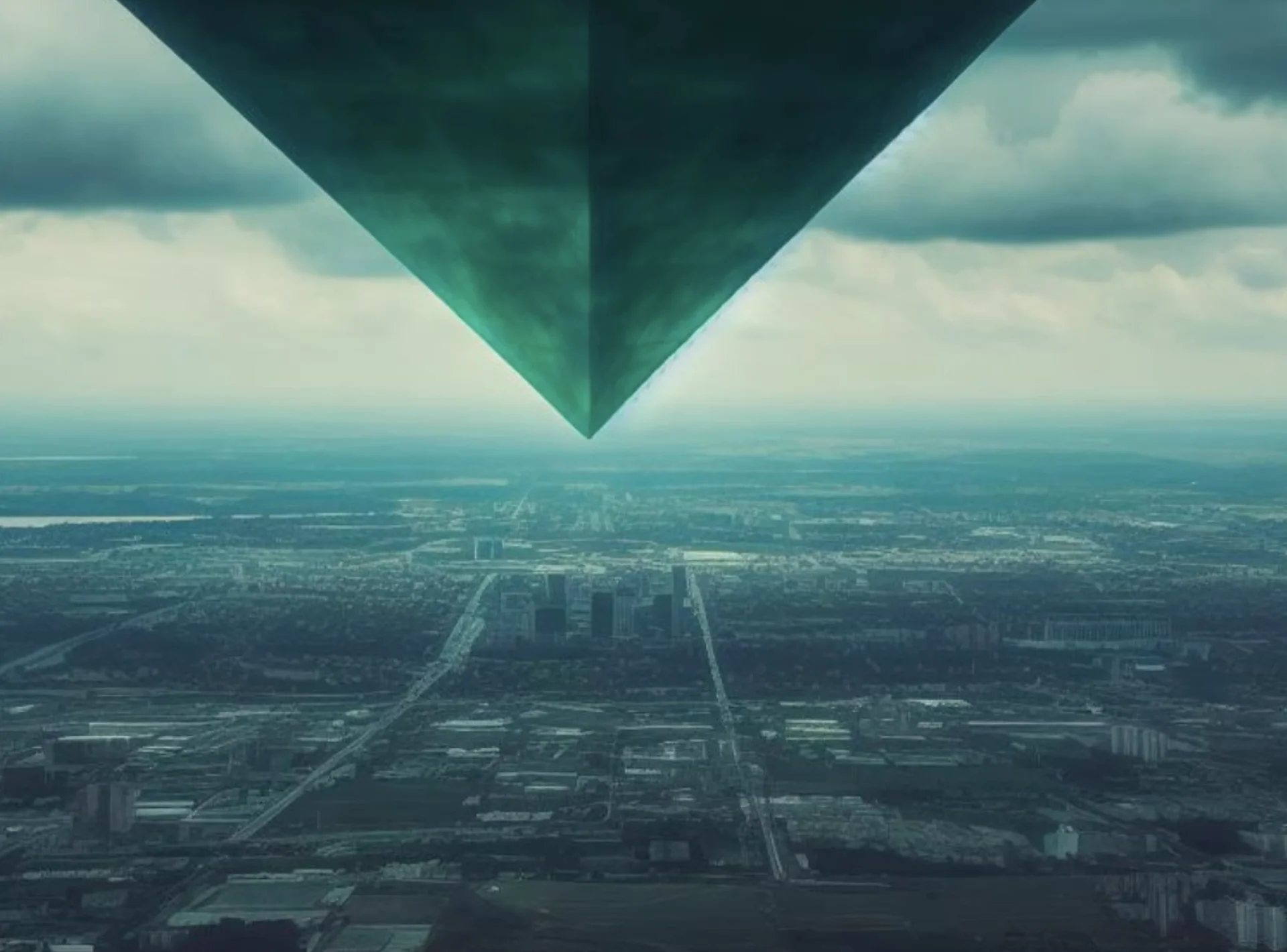 The Idol of Eirræbœ — Massive green inverted pyramid descending through clouds above an aerial cityscape