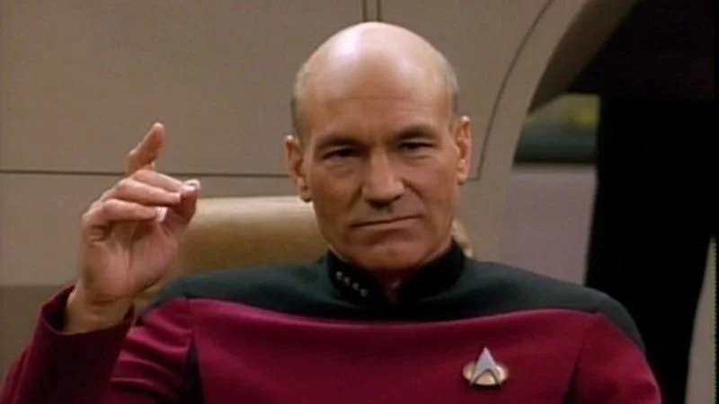 The Picard Song — Captain Picard in red Starfleet uniform raising his hand on the bridge of the Enterprise