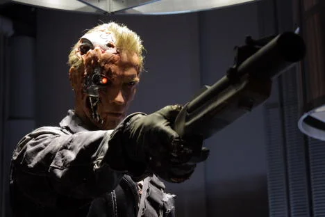 The Singularity — Cinematic scene showing a figure with visible cybernetic enhancements and mechanical components embedded in body.