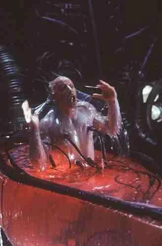 The Singularity — Dark atmospheric scene with human silhouette bathed in red and pink light from science fiction source material.