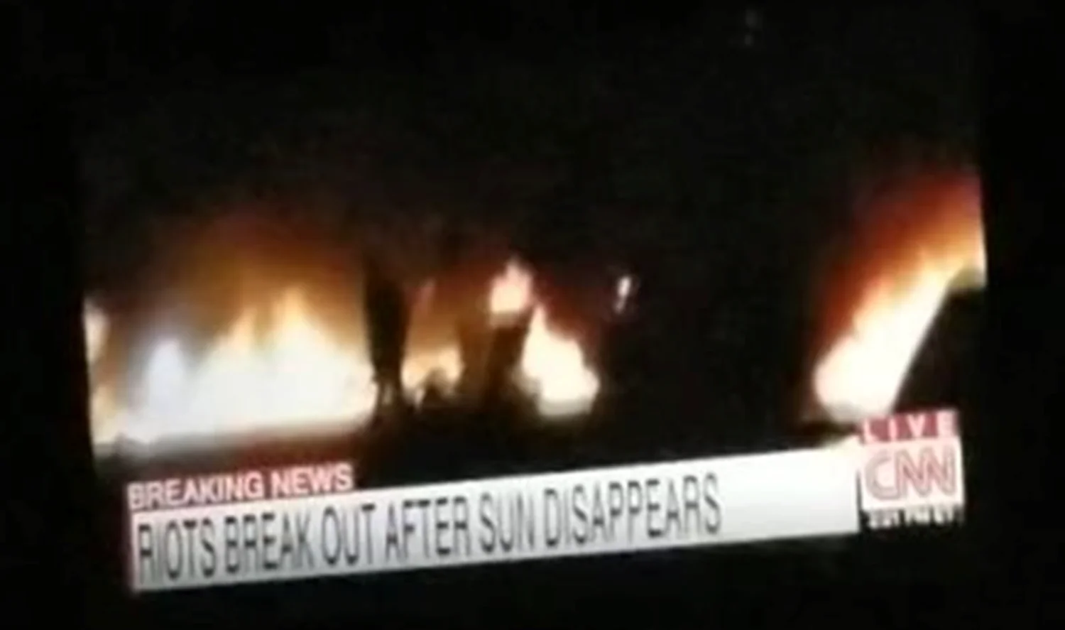 The Sun Vanished — CNN breaking news broadcast reading 'Riots break out after sun disappears' with fires visible in the background