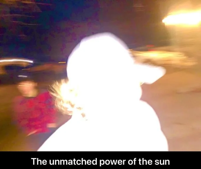 The Unmatched Power Of The Sun — Blurry nighttime photo of a hooded person washed out by a bright light with caption about the sun.