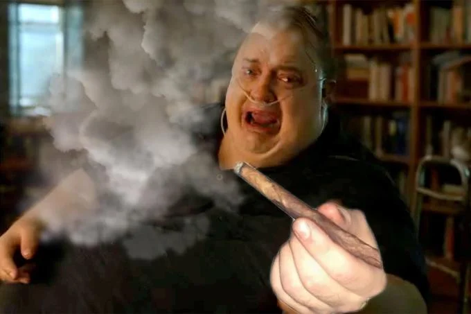 The Whale Passing a Blunt — Low-resolution still of Brendan Fraser's character in The Whale handing over a large blunt amid smoke