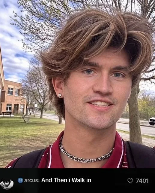 Smiling young man with brown hair, red shirt and chain necklace, captioned 'And Then i walk in'.