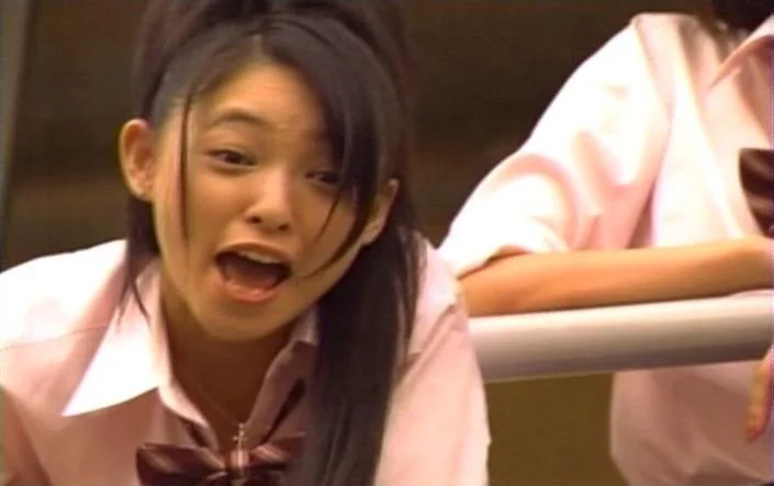 There's No Fucking Seat For You! — Japanese schoolgirl leaning on desk shouting at someone off-screen