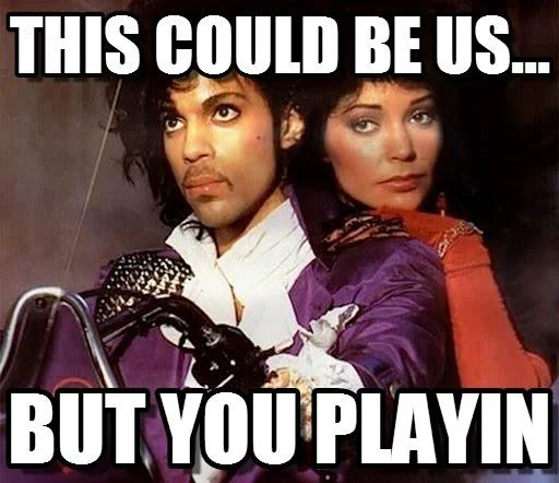 This Could Be Us But You Playing — Classic meme format with two figures in purple and red outfits with white text 'THIS COULD BE US' and 'BUT YOU PLAYIN.'