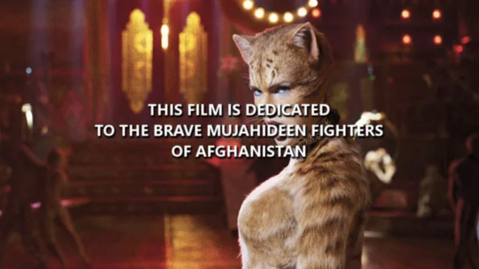 This Film Is Dedicated To The Brave Mujahideen Fighters Of Afghanistan — Meme variation with dedication text overlaid on image of cat in ornate interior