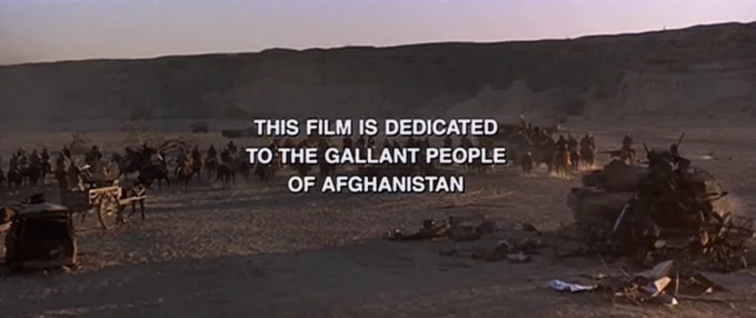 This Film Is Dedicated To The Brave Mujahideen Fighters Of Afghanistan — Rambo III ending credits scene with desert encampment and dedication text overlay.