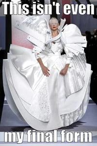 This Isn't Even My Final Form — Person wearing enormously voluminous layered white gown with sculptural proportions.