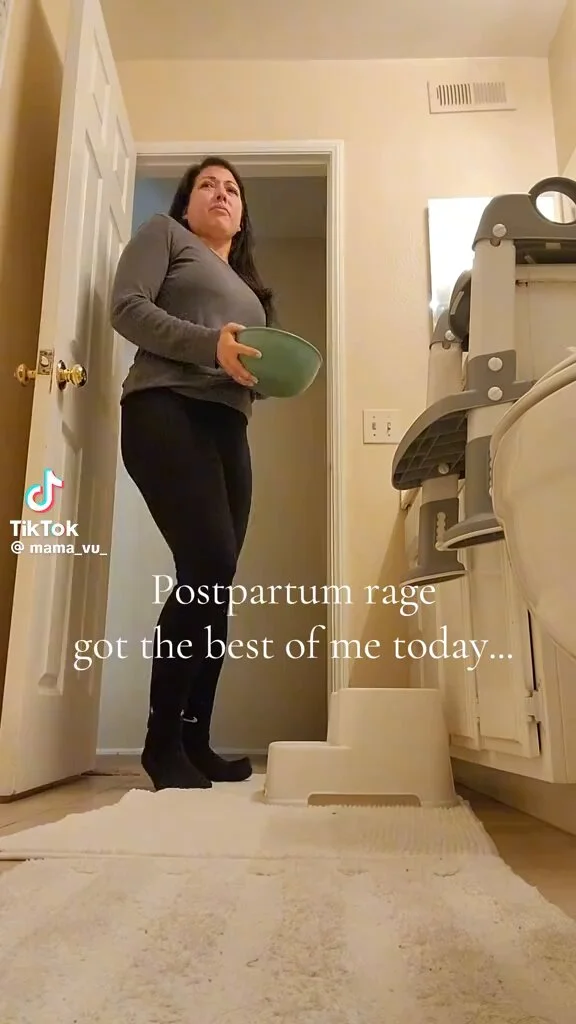Throwing Ice In Bathtub Therapy Trend — TikTok user @mama_vu_ stands in bathroom doorway holding green bowl with caption 'Postpartum rage got the best of me