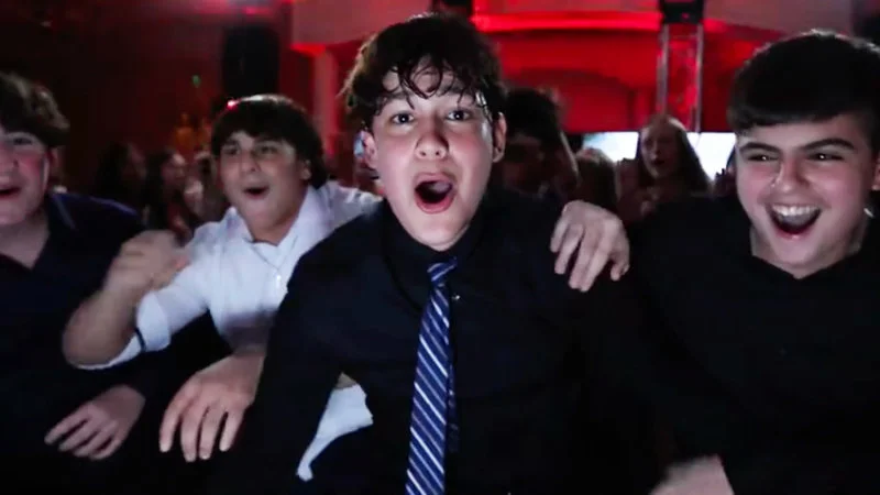 Tiktok Rizz Party — Group of teenage boys in shirts and ties cheering enthusiastically at a party