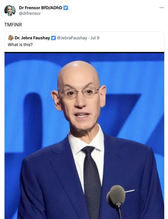 Twitter screenshot with 'TMFINR' reply to a photo of a bald man in a suit at a press conference