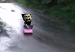 Tokyo Drift In A Barbie Car — Closeup aerial view of man drifting on pink Barbie toy.