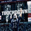 Touchdown Tom — Stadium photo of Tom Brady in Patriots jersey with massive TOUCHDOWN graphic on scoreboard.