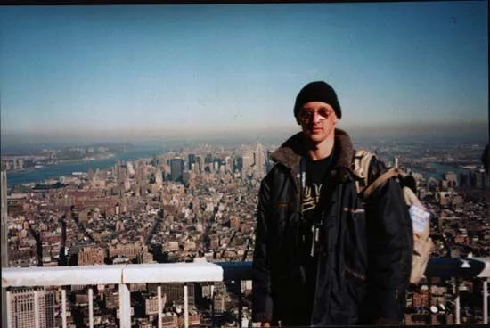 Iconic Tourist Guy meme in clean cropped format with Twin Towers skyline.