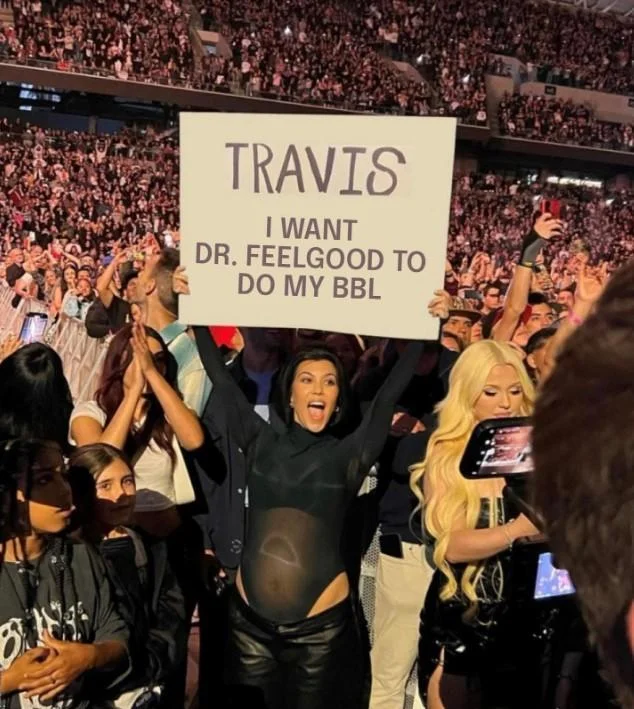 Travis I'm Pregnant Sign — Edited Kourtney Kardashian meme with sign reading 'Travis I want Dutch Bros'.