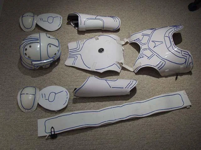 Tron Guy — Disassembled white Tron costume armor pieces laid out on floor
