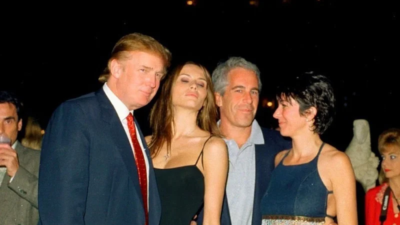 Trump Body Count — Historical photograph of Donald Trump and Jeffrey Epstein together at 1990s social gathering.