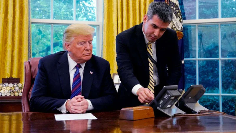 Trump Calling Enrique Pena Nieto — Trump seated at Oval Office desk as aide operates conference speakerphone.