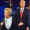 Trump Lurking Behind Clinton — News photograph from October 9, 2016 debate showing Trump looming behind Clinton.