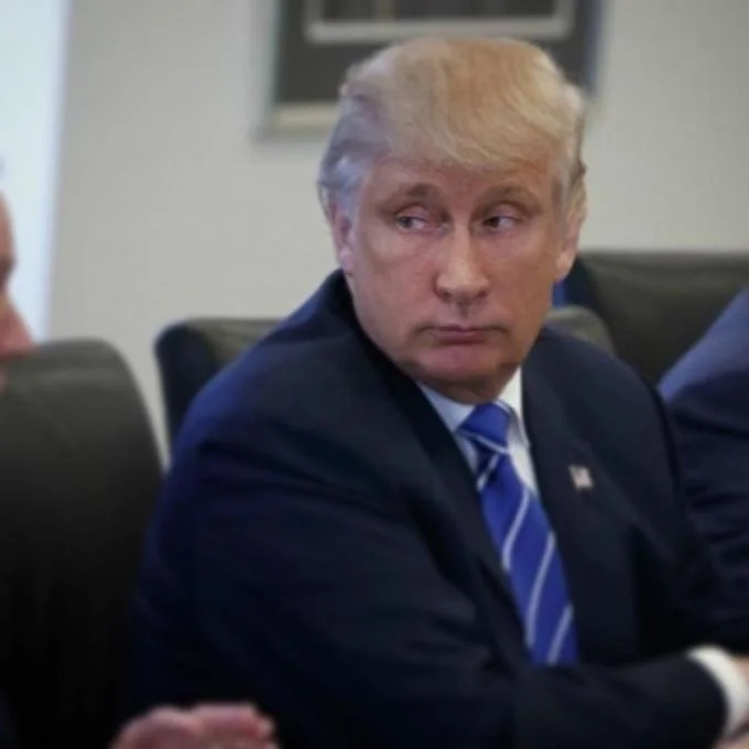 Trumputin — Trump at a conference table with Putin-style eyes photoshopped onto his face